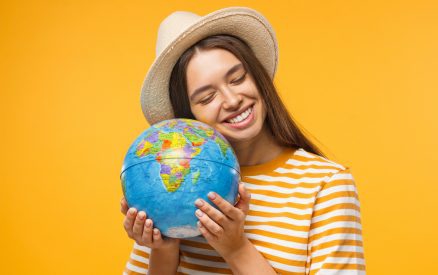 Young women holding a globe