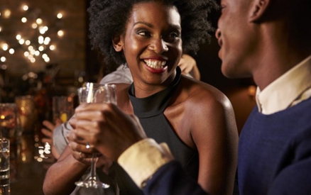 Young romantic couple enjoying drinks at a bar