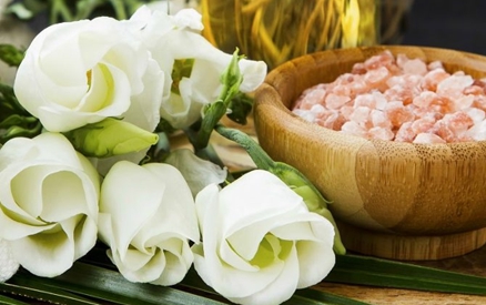 still shot of spa products, including a towel and pink salts